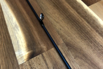 A wooden floor with some metal rods on it