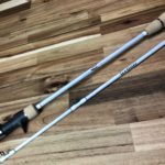 Two poles are sitting on a wooden floor.
