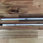 A pair of white poles on top of a wooden floor.