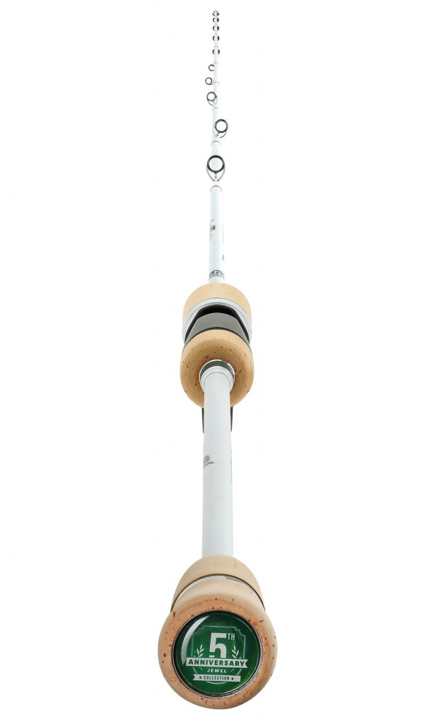 A tall tower with a ring hanging from it's top.